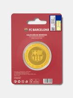 Gold coin with FC Barcelona logo on a red packaging