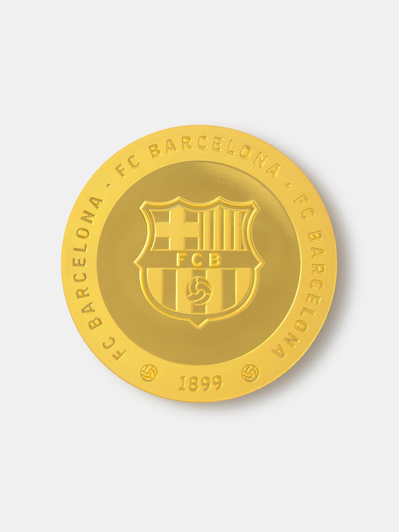 Gold coin with FC Barcelona logo on a white background