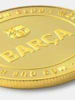 Gold coin with 'BARÜa' and a logo on a white background