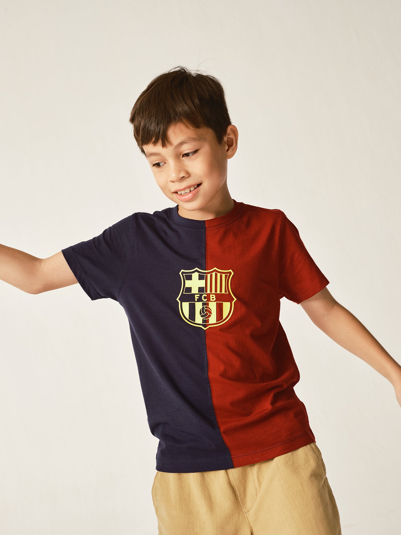 half navy and half red FC Barcelona t-shirt with a large vintage-style club crest in the center.