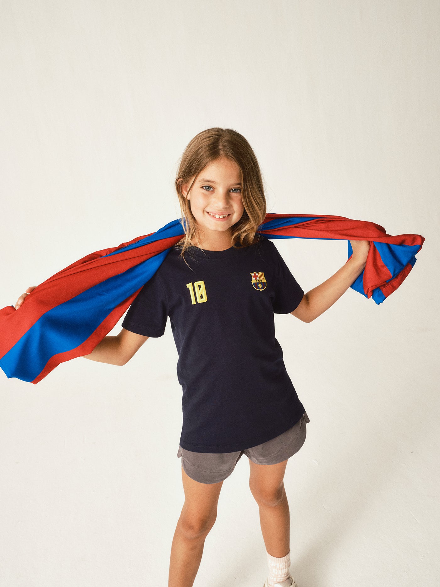  navy FC Barcelona jersey with 'BARÇA' text and the number 10 printed in bold yellow.