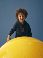 navy blue FC Barcelona hoodie featuring the club crest on the chest and "Barça" embroidered on the sleeve.