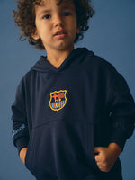 navy blue FC Barcelona hoodie featuring the club crest on the chest and "Barça" embroidered on the sleeve.