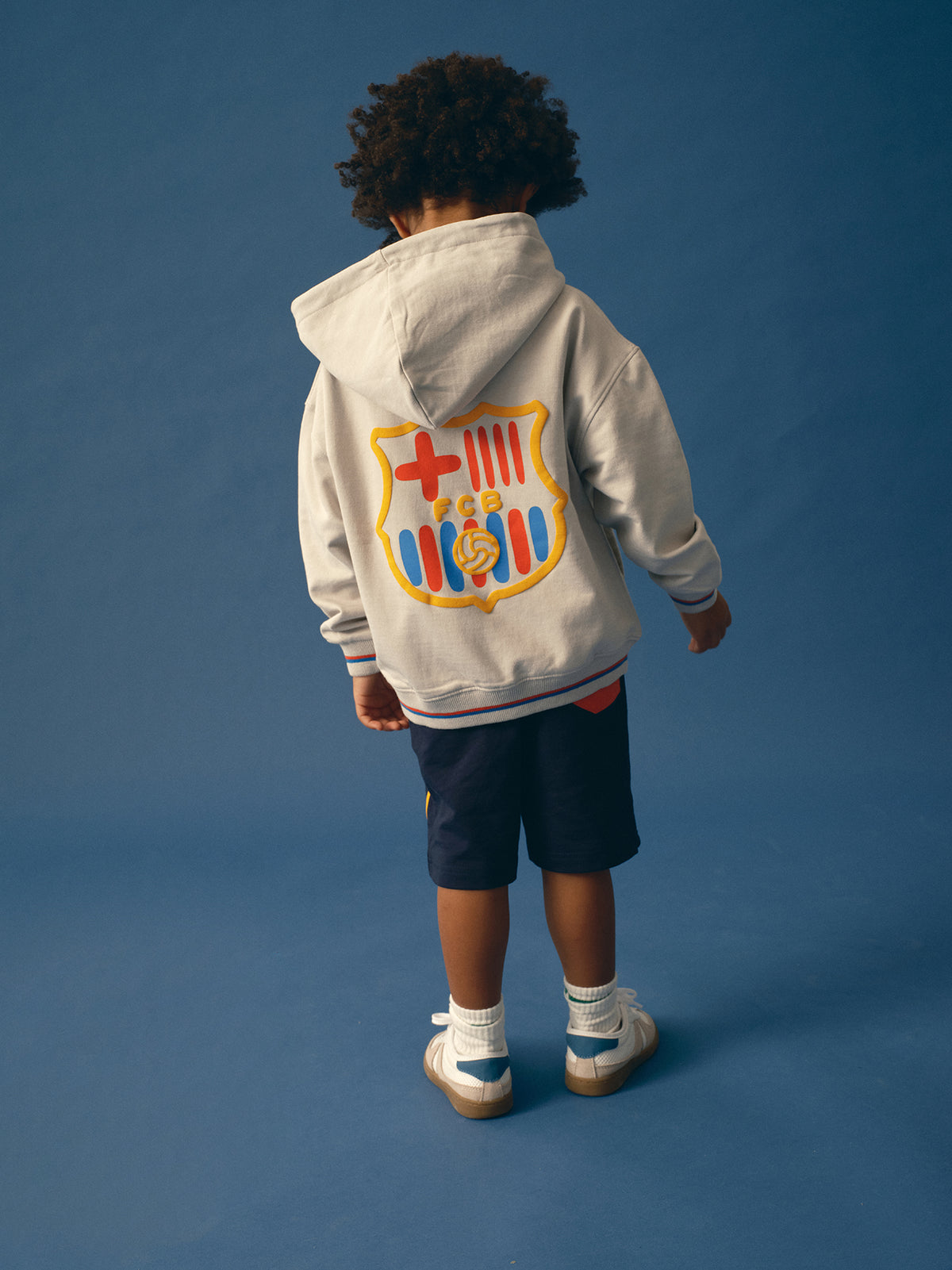 light grey FC Barcelona zip-up hoodie with the club crest on the chest and "Barça" text embroidered in blue.