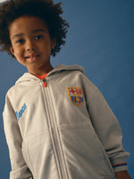 light grey FC Barcelona zip-up hoodie with the club crest on the chest and "Barça" text embroidered in blue.