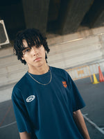 navy blue FC Barcelona t-shirt with the text 'CULERS OF THE WORLD' in orange and a white line illustration of a footballer kicking a ball.