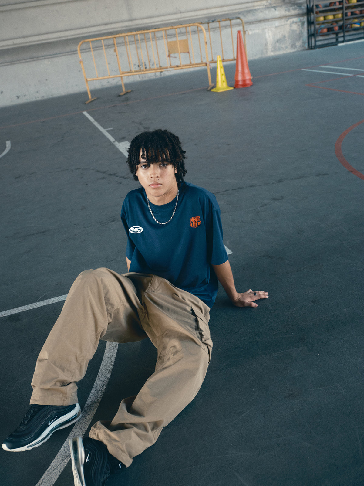 navy blue FC Barcelona t-shirt with the text 'CULERS OF THE WORLD' in orange and a white line illustration of a footballer kicking a ball.