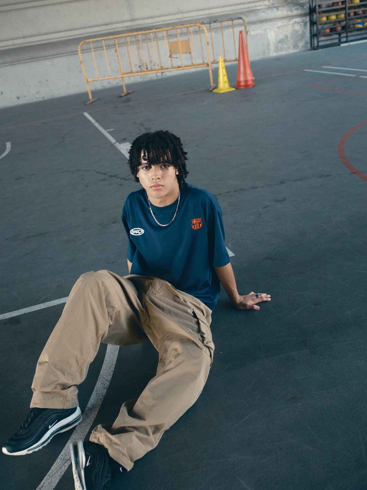 navy blue FC Barcelona t-shirt with the text 'CULERS OF THE WORLD' in orange and a white line illustration of a footballer kicking a ball.