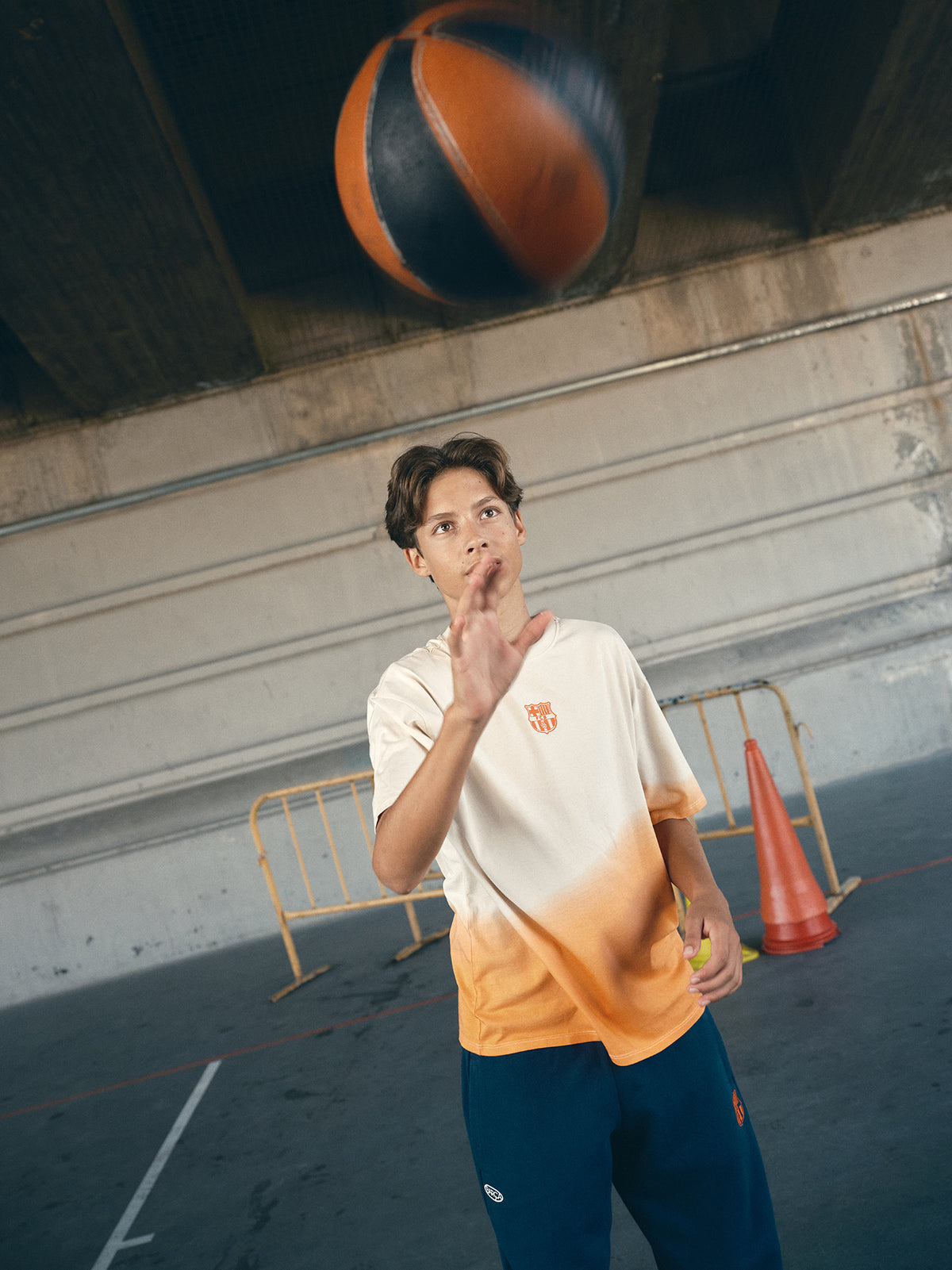 beige and orange gradient FC Barcelona t-shirt with 'EST. 1899' printed in bold orange text.