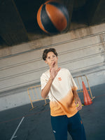beige and orange gradient FC Barcelona t-shirt with 'EST. 1899' printed in bold orange text.
