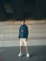 navy blue FC Barcelona hoodie featuring a front zipper and an orange graffiti-style 'FCB' logo printed on the chest