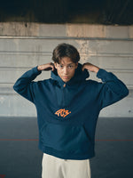 navy blue FC Barcelona hoodie featuring a front zipper and an orange graffiti-style 'FCB' logo printed on the chest