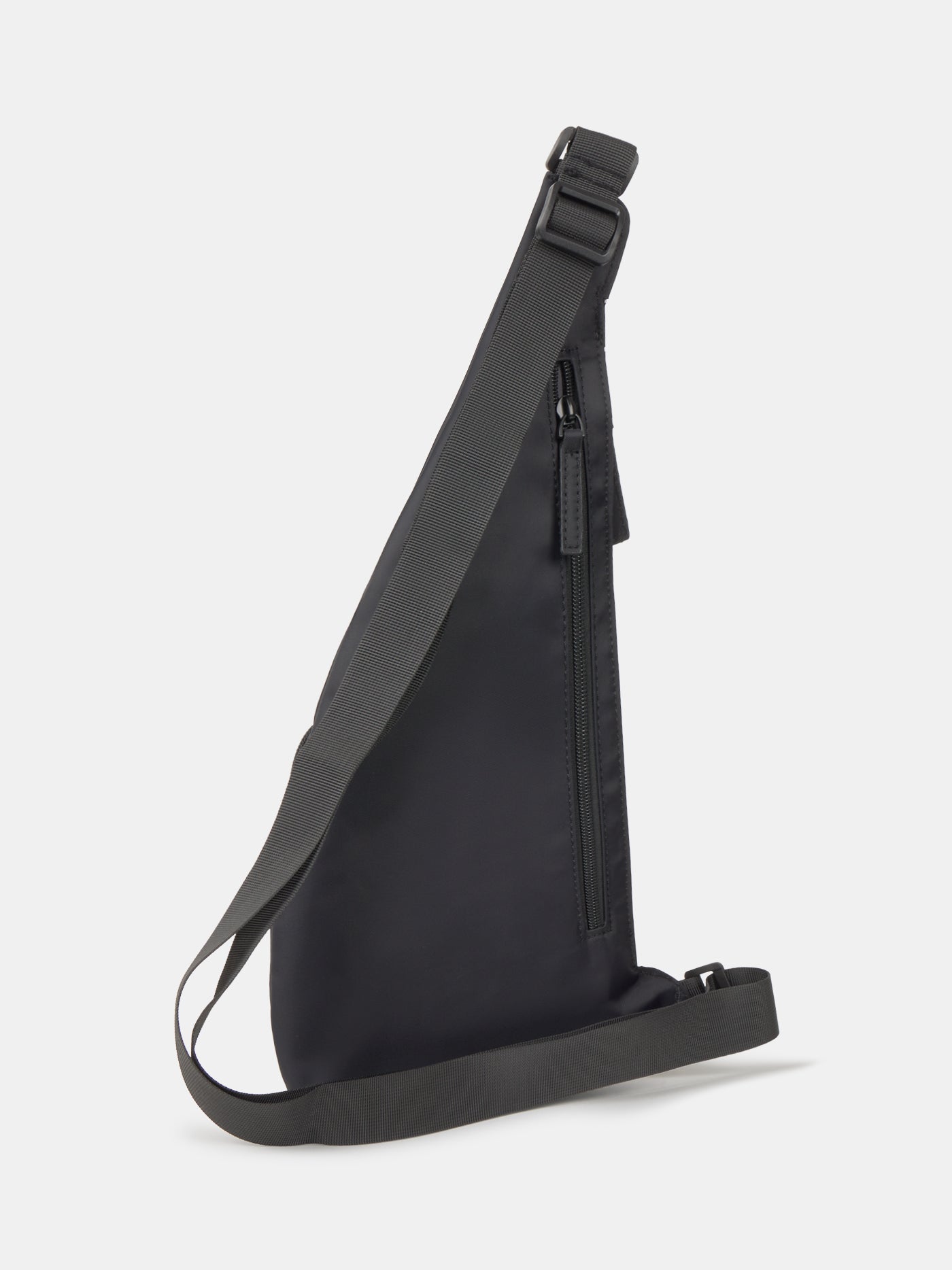 Black FC Barcelona crossbody bag with multiple zippered compartments and metallic club crest on the front pocket.