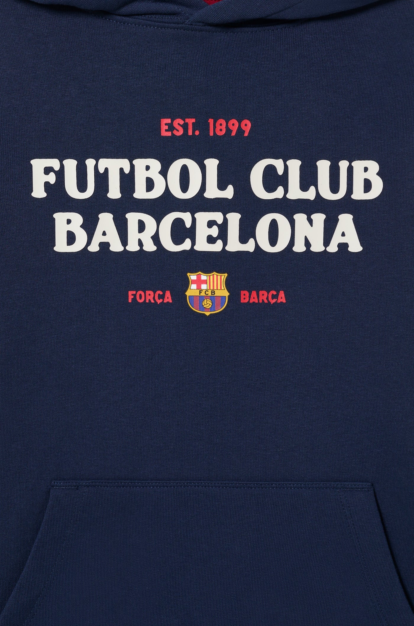 Navy blue FC Barcelona hoodie with front kangaroo pocket. The front displays white and red text reading “EST. 1899 FUTBOL CLUB BARCELONA” above the club’s crest, accompanied by the words “FORÇA BARÇA” in smaller text on each side of the crest.