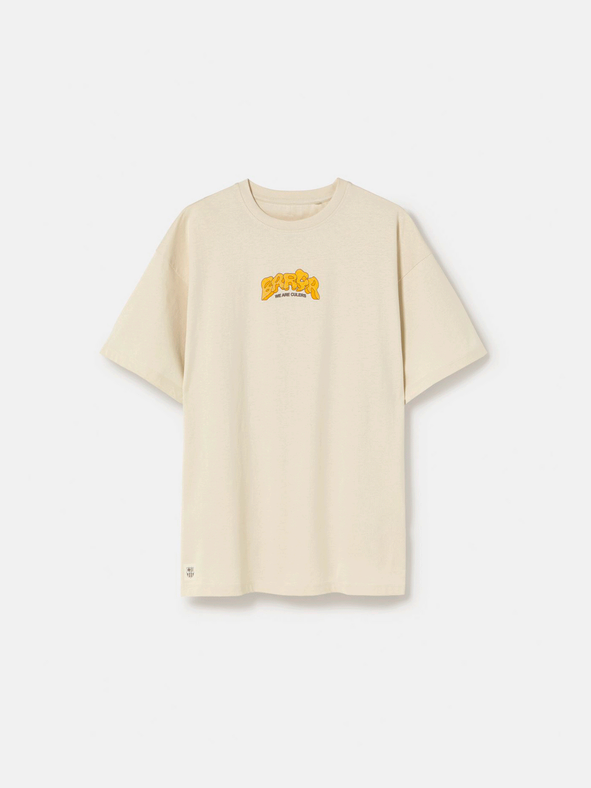 Beige FC Barcelona T-shirt featuring a vibrant vintage-style back print with the word "Barça" in large retro bubble letters. The graphic includes a football, flags, and stadium elements in bold colors within a shield-like frame. A ribbon below the design reads “Since 1899” and “Més que un club.”