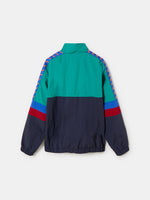 Retro-style windbreaker in teal, red, blue, and navy with FC Barcelona crest and embroidered 'Barça' text on the chest.