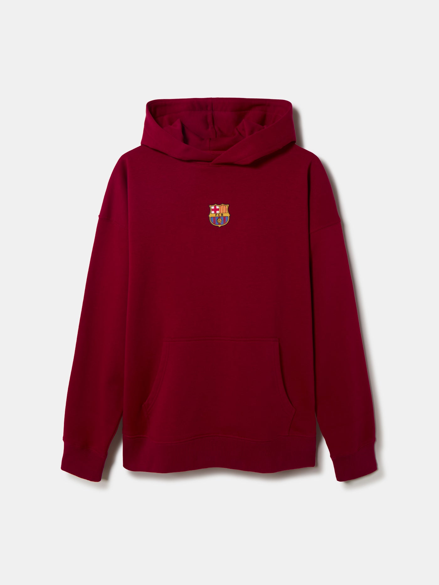 Woman wearing a red FC Barcelona hoodie featuring the club’s crest on the chest. She is adjusting the hood with both hands while slightly turning her head to the side, showing off gold hoop earrings.








