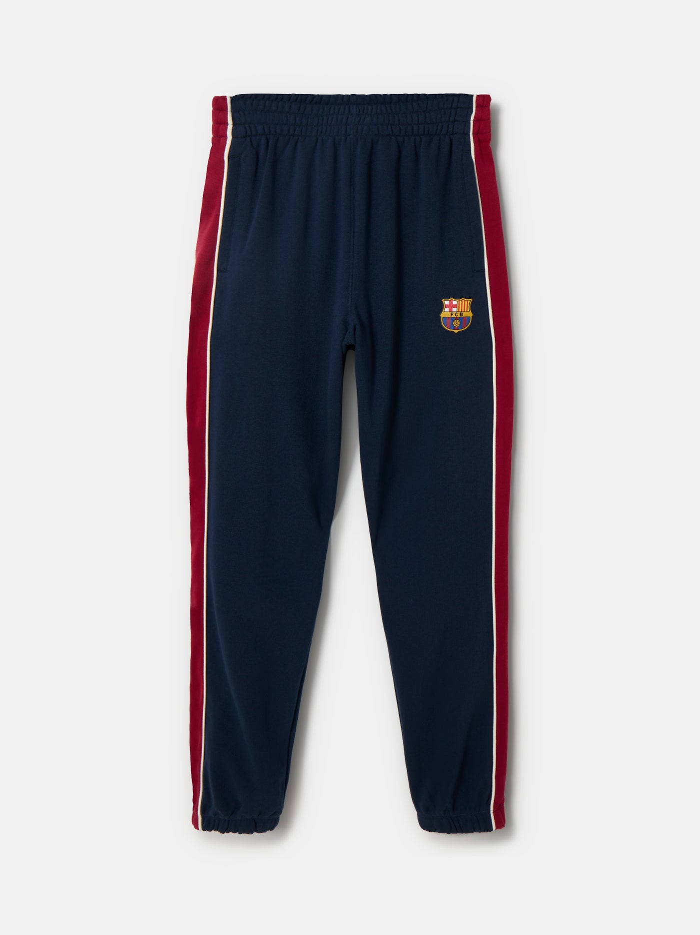 Navy blue FC Barcelona track pants with red side panels and white piping. The pants feature the club crest on the upper left leg and have an elastic waistband and cuffs for a comfortable fit.









