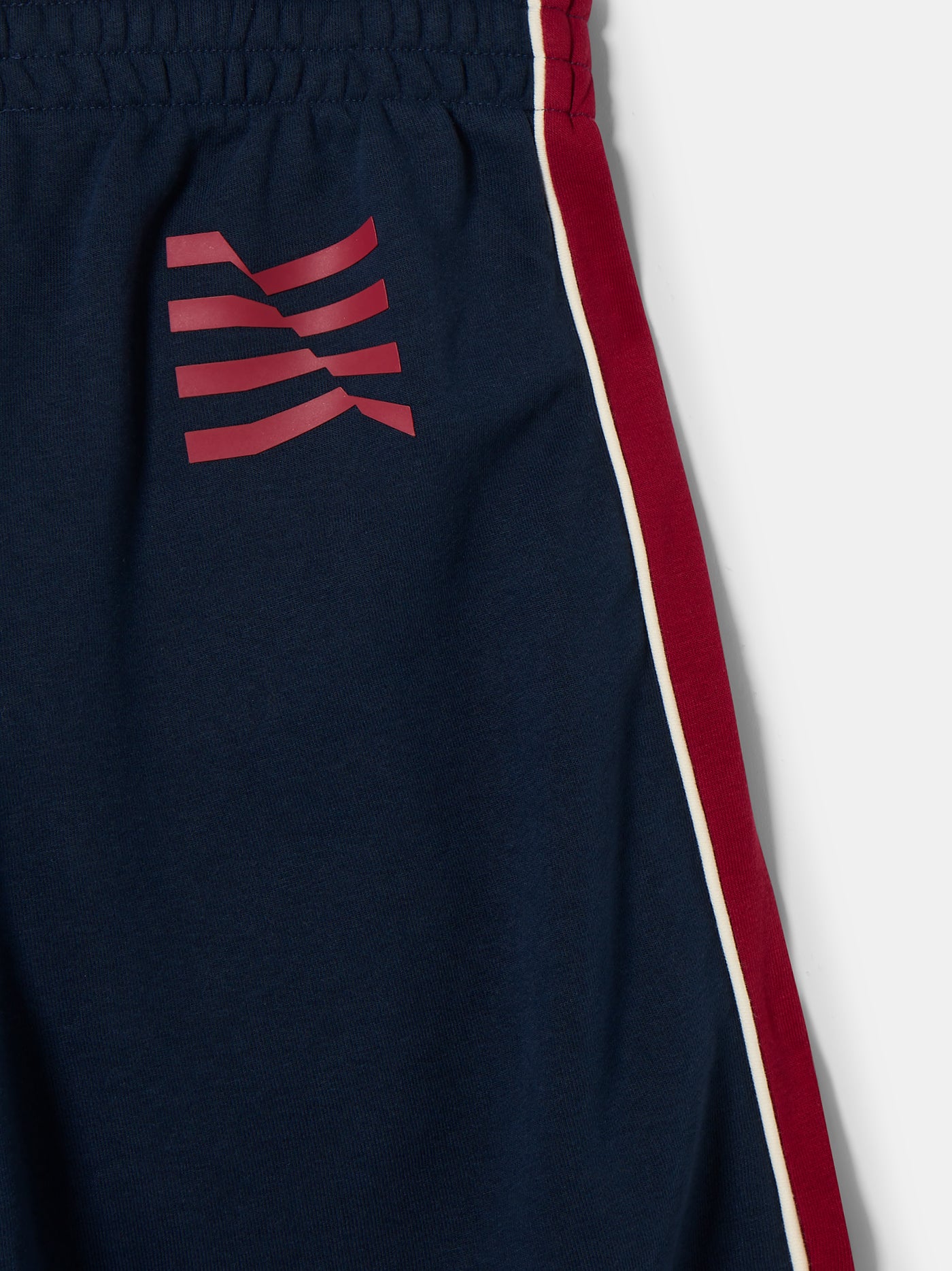 Navy blue FC Barcelona track pants with red side panels and white piping. The pants feature the club crest on the upper left leg and have an elastic waistband and cuffs for a comfortable fit.






