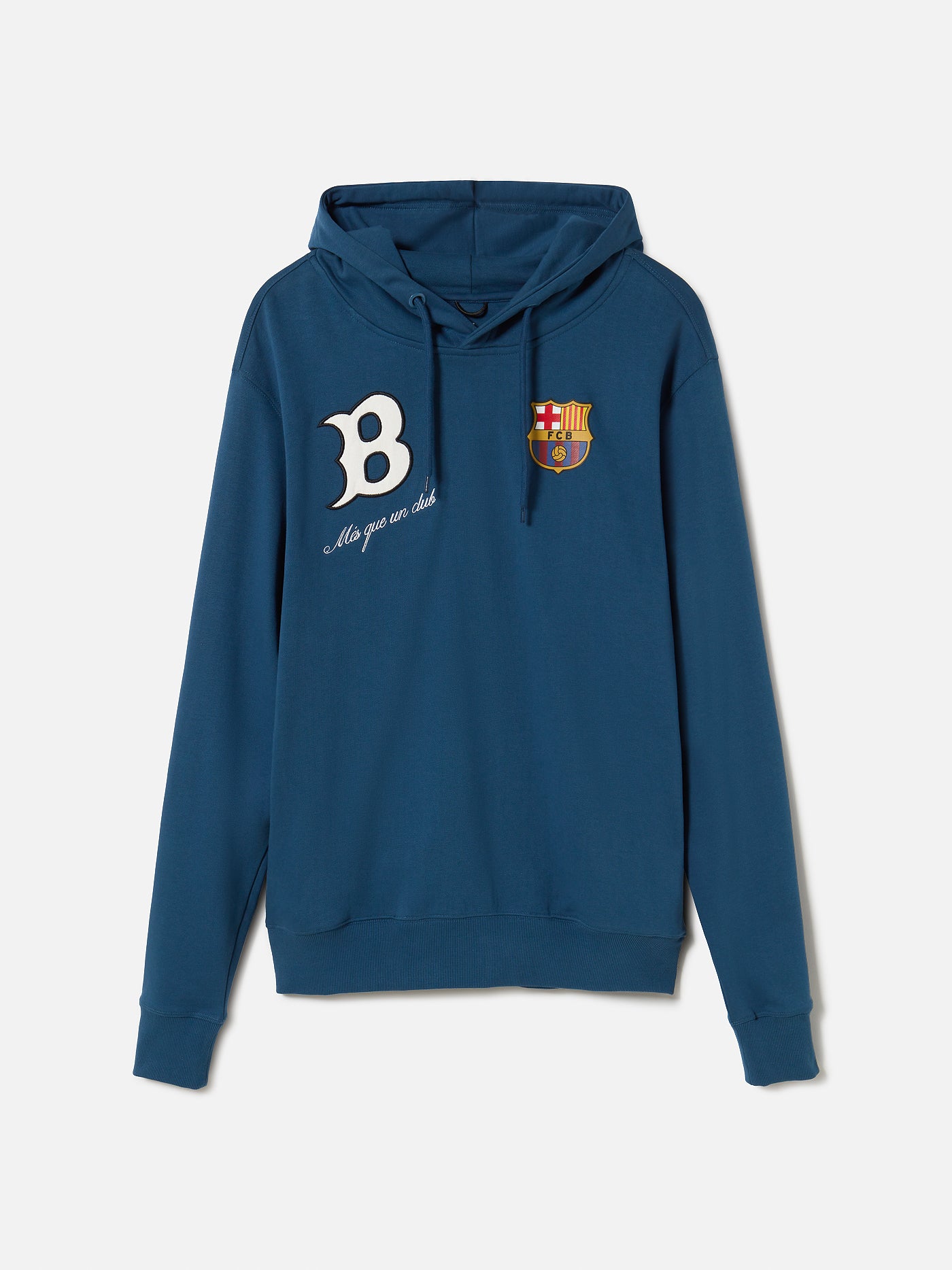 Man wearing a blue FC Barcelona hoodie, sitting with hands clasped. The hoodie features a white “B” on the left side with the phrase “Més que un club” below it, and the official FC Barcelona crest on the right side.









