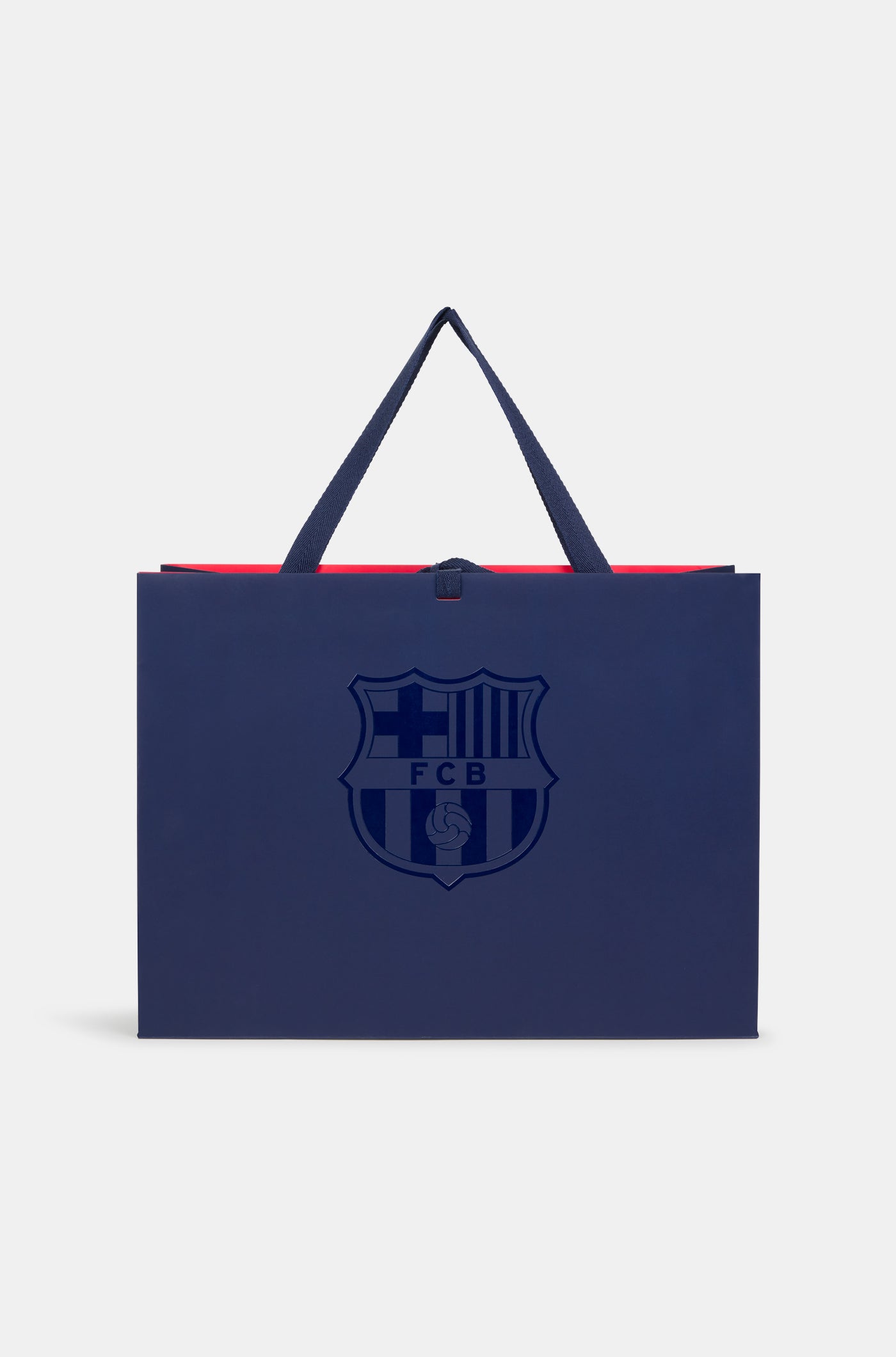 Dark blue FC Barcelona gift bag with glossy club crest on the front and dark blue handles, featuring a red interior.