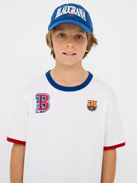 Blue FC Barcelona cap with "BLAUGRANA 1899" embroidered in white and red on the front, featuring a curved brim and a small Barça crest on the side.
