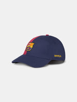 Half red, half navy blue baseball cap with the FC Barcelona crest on the front and 'Barça' text on the side.