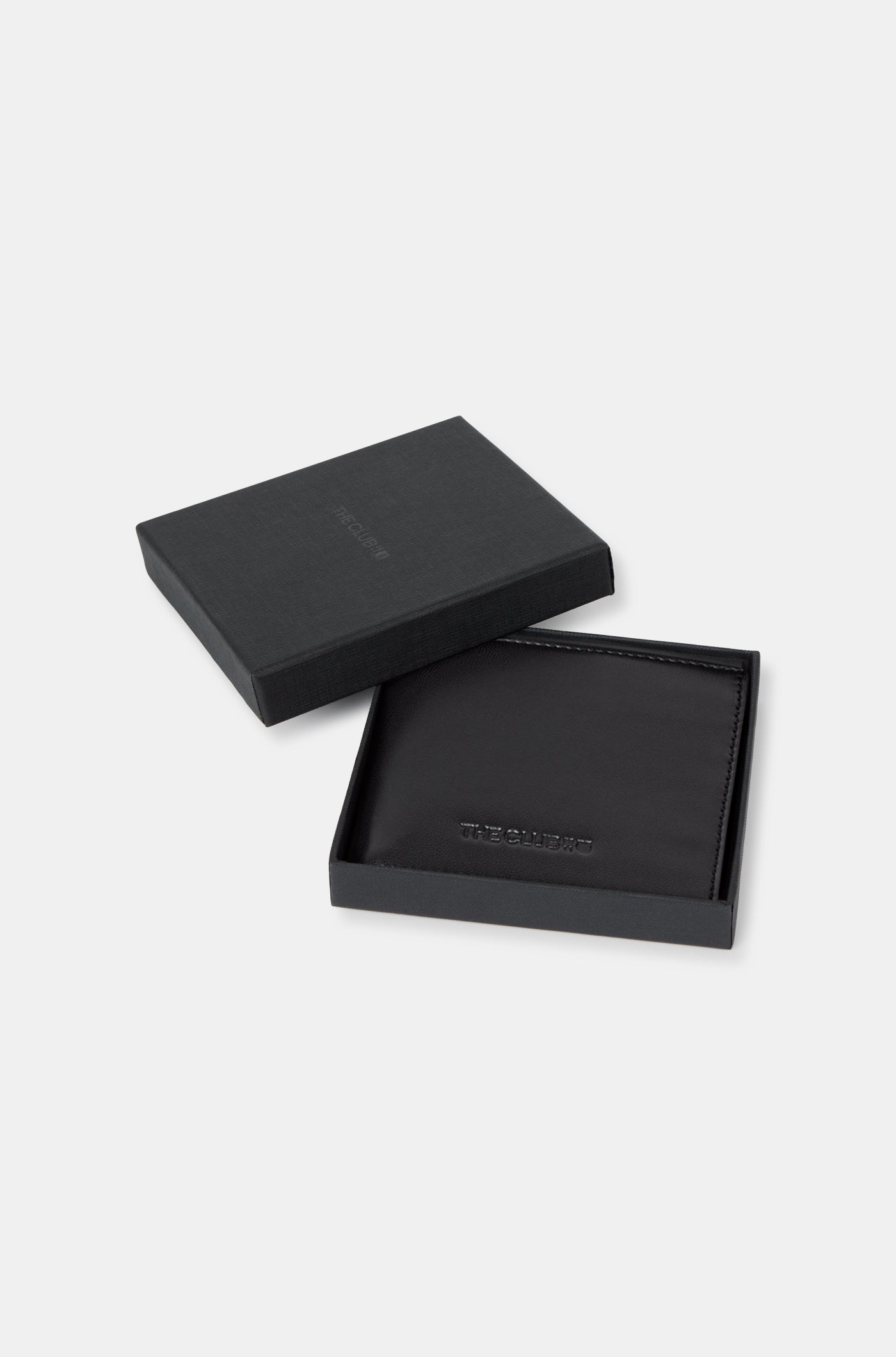 Close-up of a black leather wallet with an embossed FC Barcelona logo on the corner.