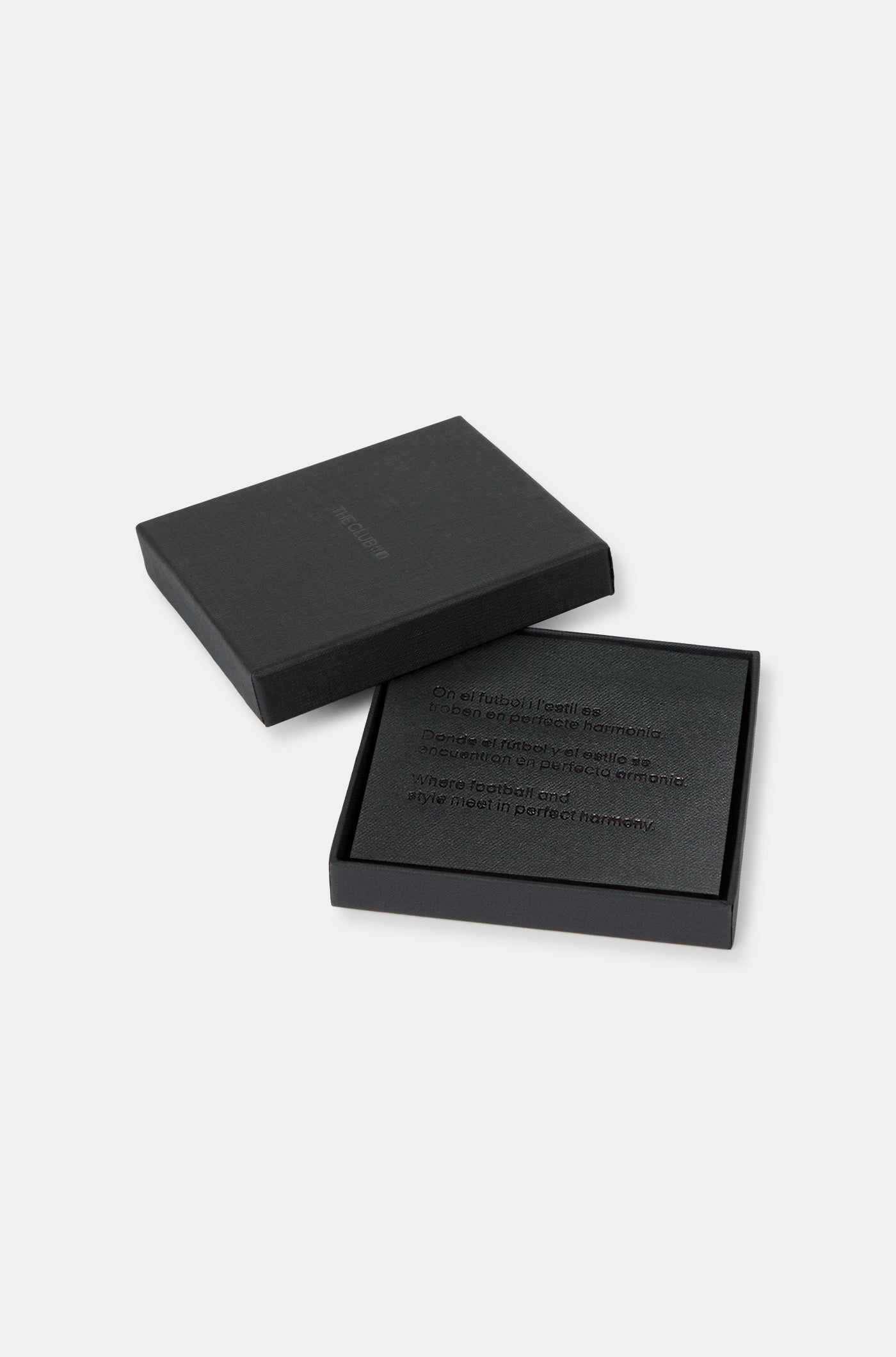 Close-up of a black leather wallet with an embossed FC Barcelona logo on the corner.