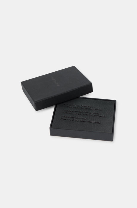 Black leather cardholder with embossed “THE CLUB” text on the front, featuring two horizontal card slots.