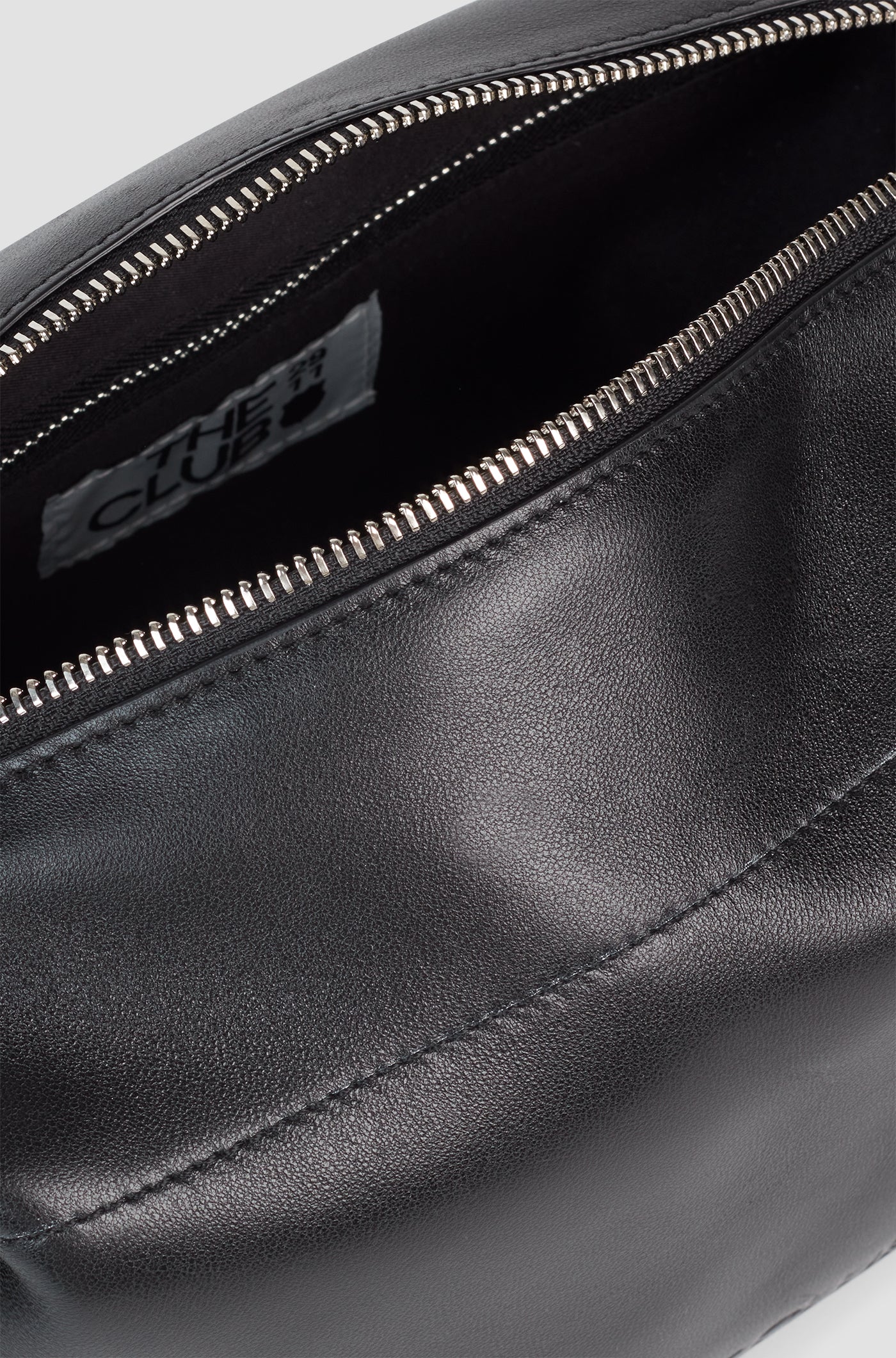 Black leather toiletry bag with a side handle and a silver zipper, featuring an embossed FC Barcelona logo.