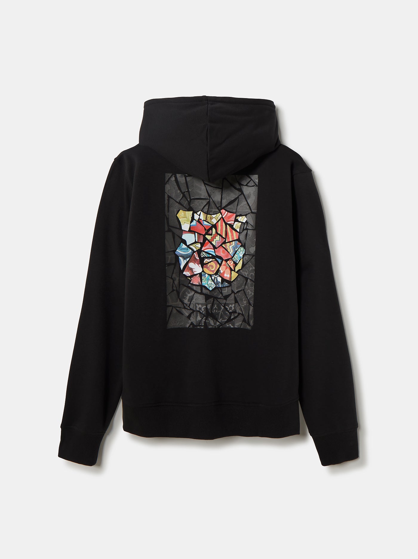 Person wearing a black hoodie featuring a mosaic-style artwork on the back in the shape of the FC Barcelona crest, filled with vibrant patterns and colors reminiscent of Antoni Gaudí's style.