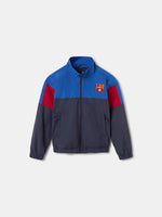 Color-block windbreaker jacket in blue, red, and navy with FC Barcelona crest on the chest