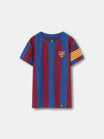 FC Barcelona kids’ T-shirt with blue and maroon vertical stripes, embroidered club crest on the chest, and yellow-red striped armband detail on the sleeve