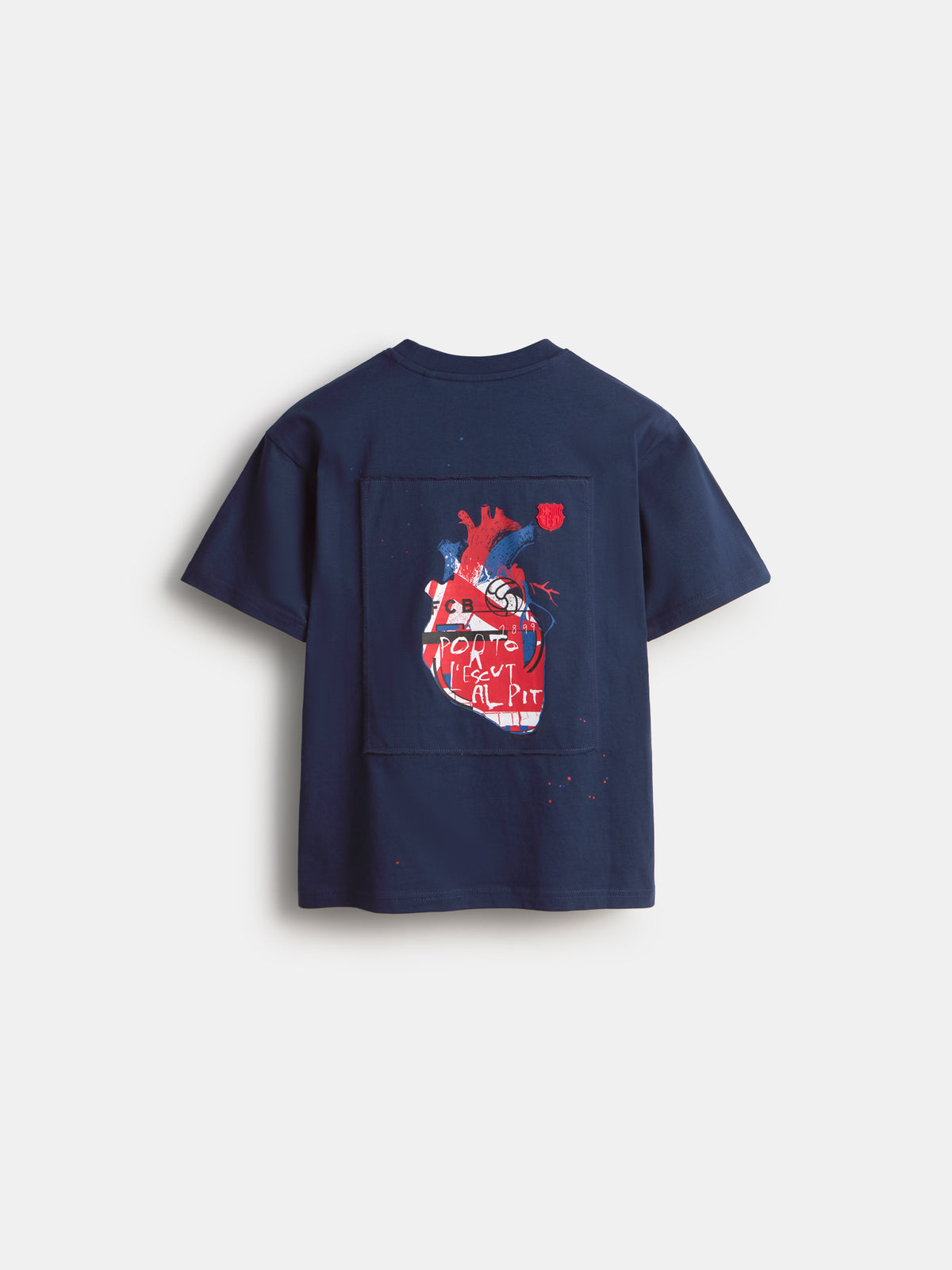 Back view of a navy FC Barcelona T-shirt with a large rectangular graphic print on the back featuring a stylized red and blue heart.