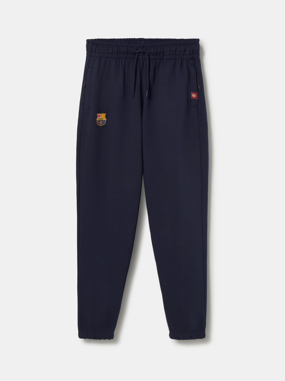Navy blue FC Barcelona joggers featuring the club crest on the left leg and an elastic waistband with drawstrings