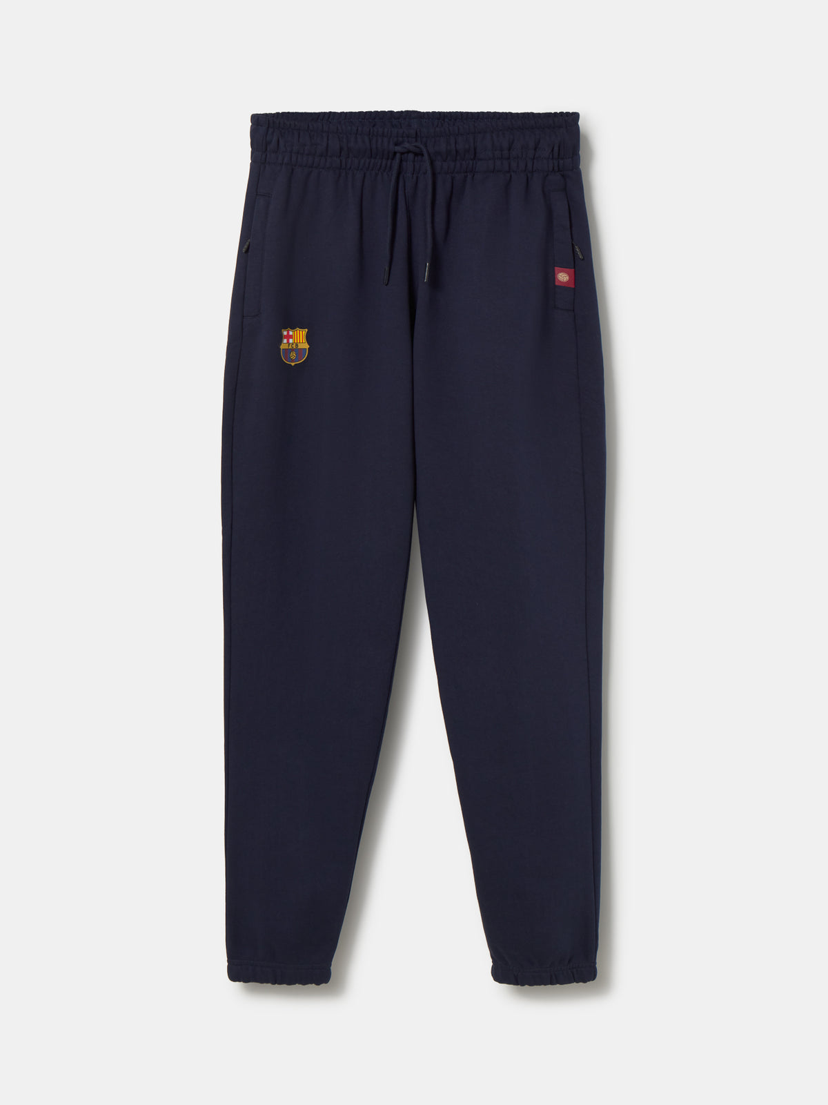 Navy blue FC Barcelona joggers featuring the club crest on the left leg and an elastic waistband with drawstrings