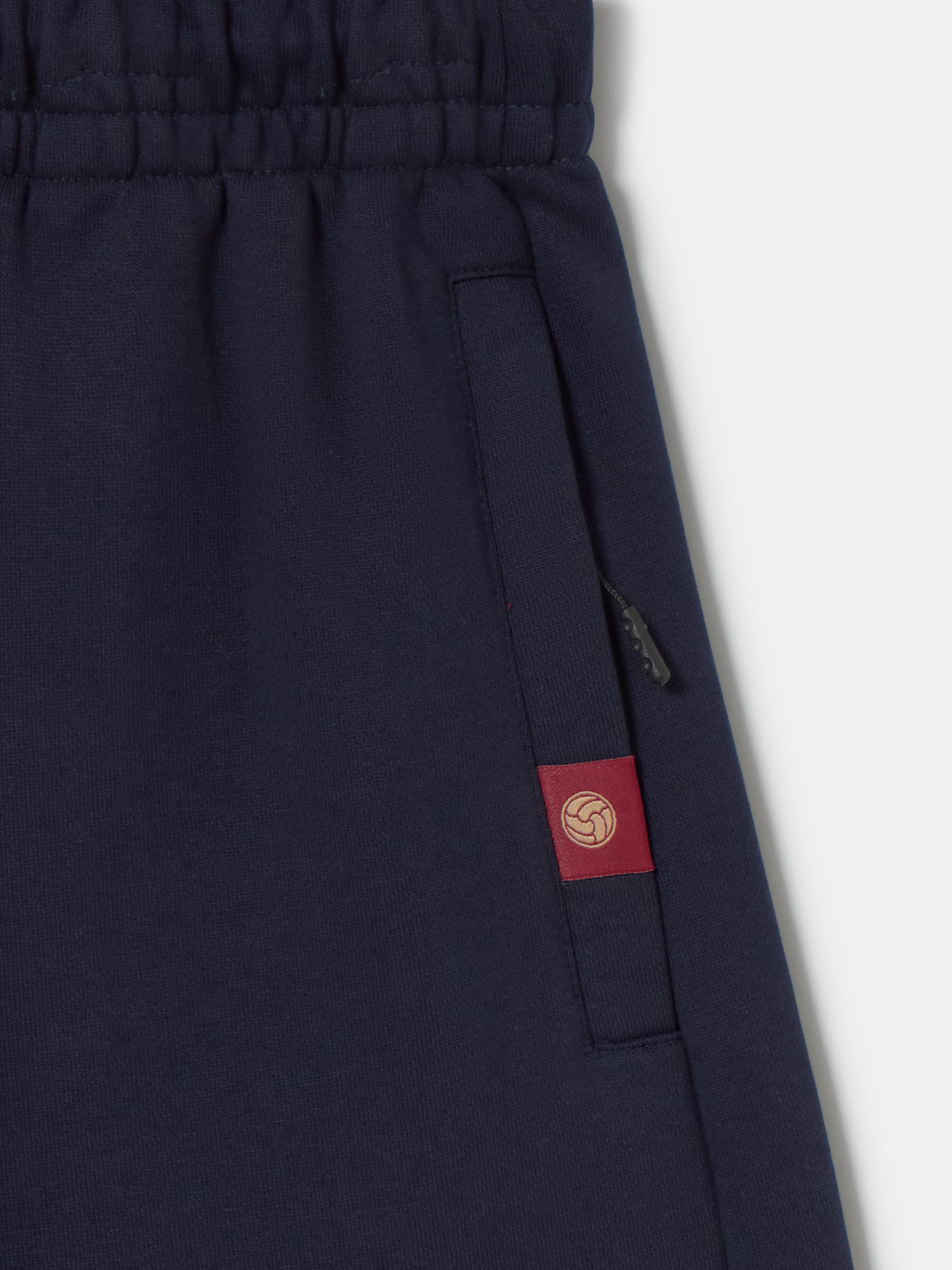 Navy blue FC Barcelona joggers featuring the club crest on the left leg and an elastic waistband with drawstrings