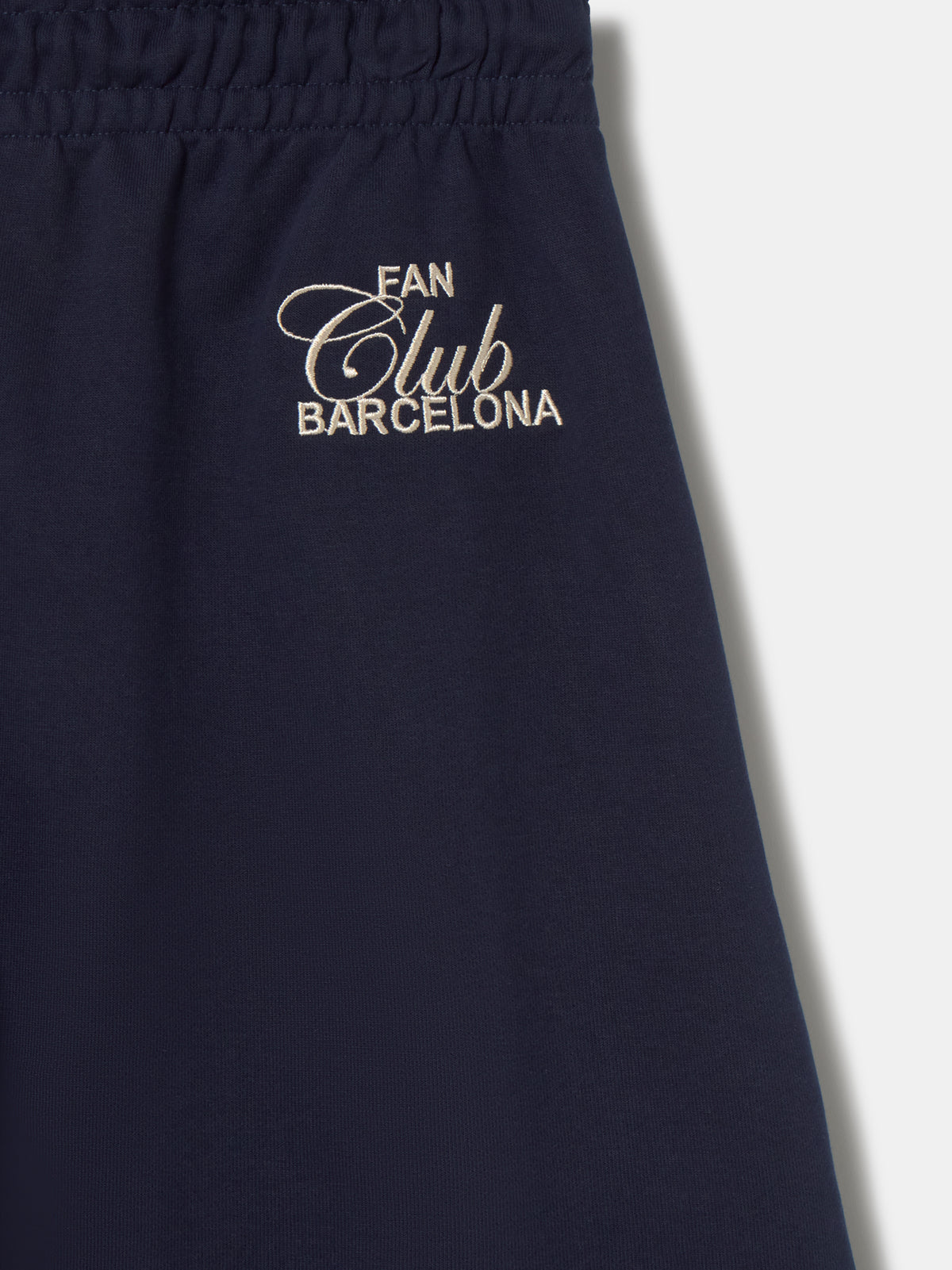 Navy blue FC Barcelona joggers featuring the club crest on the left leg and an elastic waistband with drawstrings