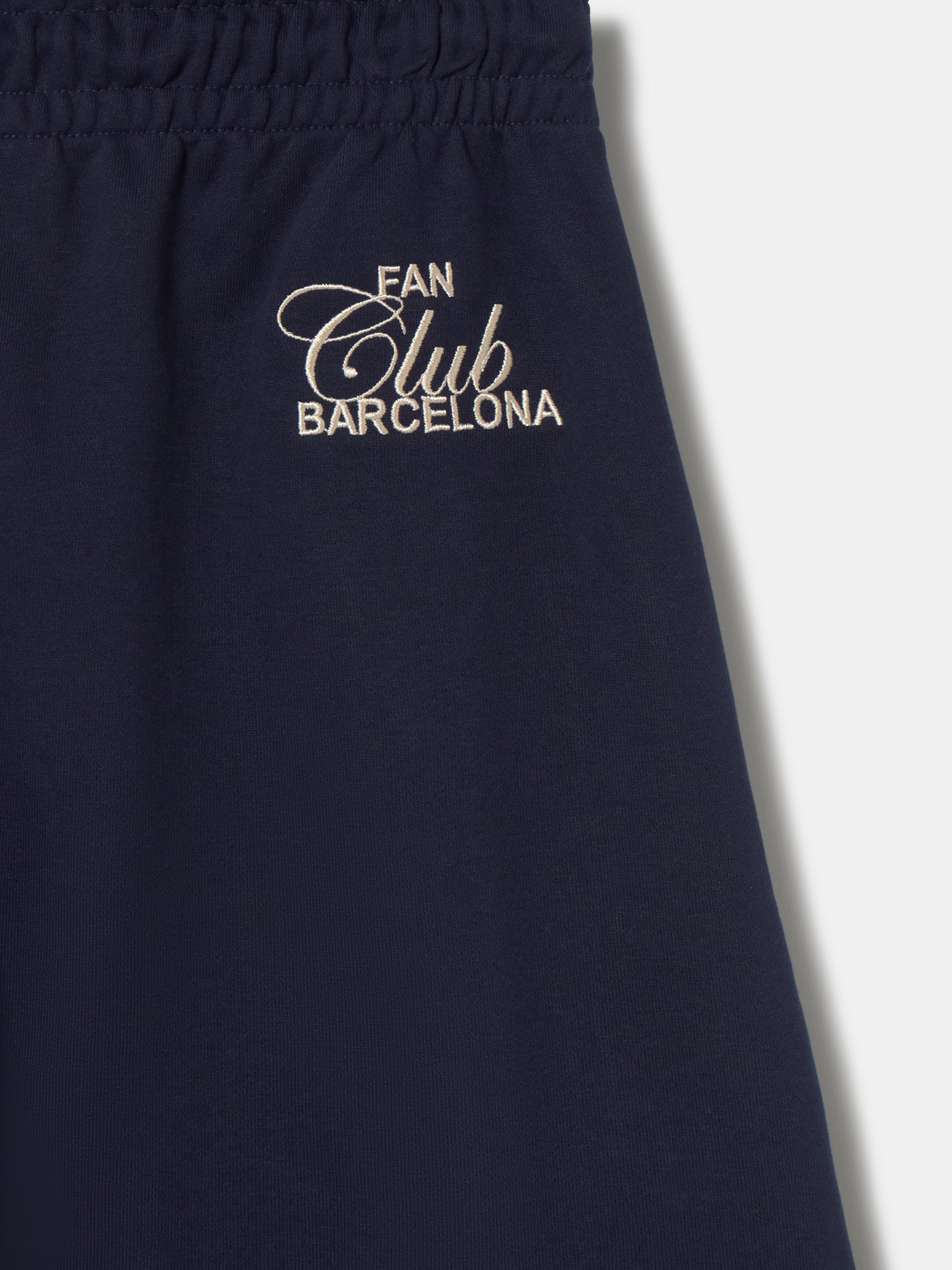 Navy blue FC Barcelona joggers featuring the club crest on the left leg and an elastic waistband with drawstrings
