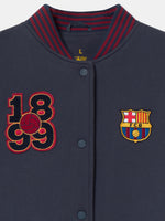 Navy blue FC Barcelona varsity jacket with embroidered 1899 detail, club crest on the chest, and red striped collar, cuffs, and hem.