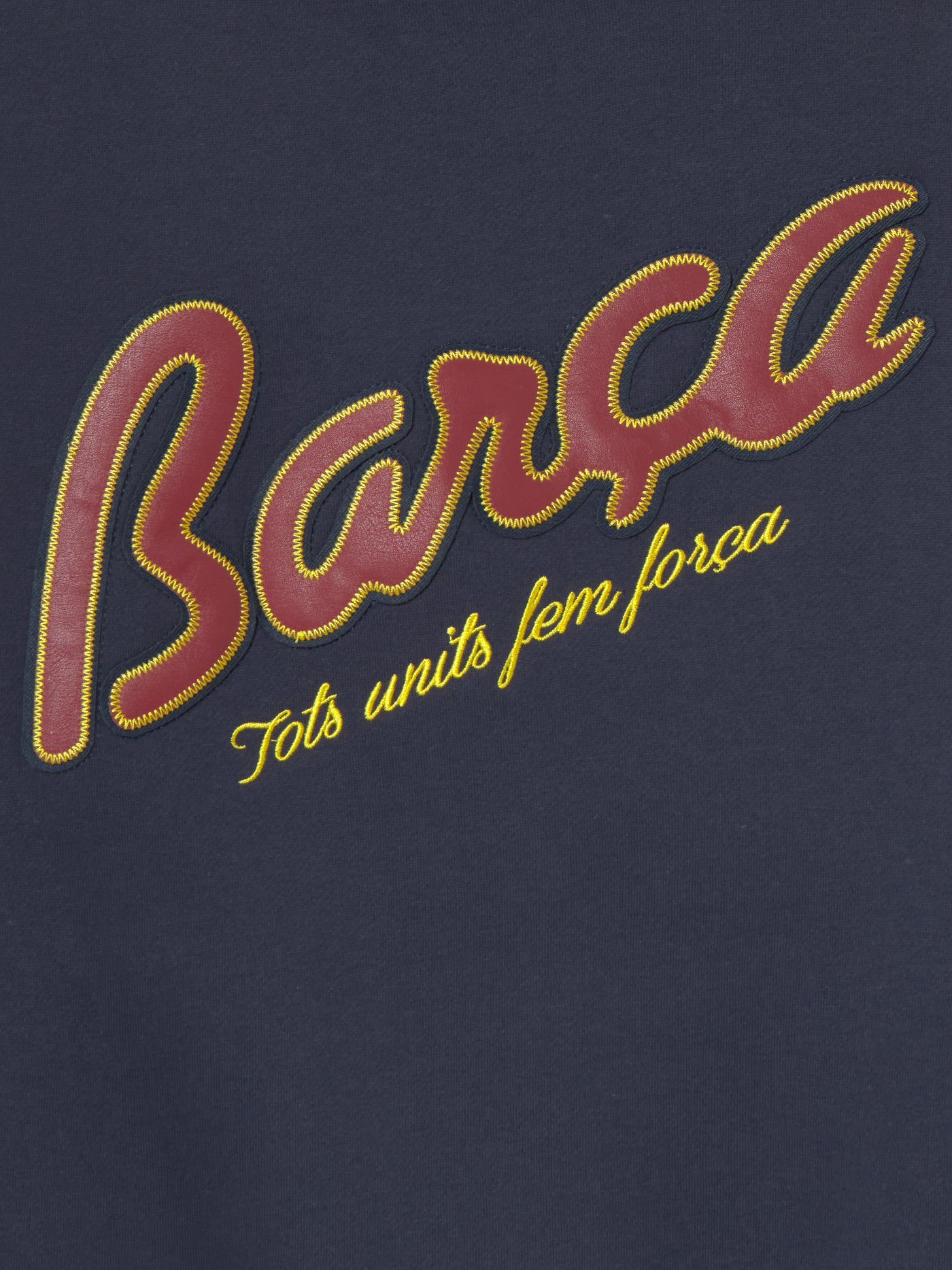 Navy blue FC Barcelona varsity jacket with embroidered 1899 detail, club crest on the chest, and red striped collar, cuffs, and hem.