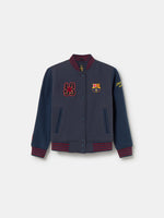 Navy blue FC Barcelona varsity jacket with embroidered 1899 detail, club crest on the chest, and red striped collar, cuffs, and hem.