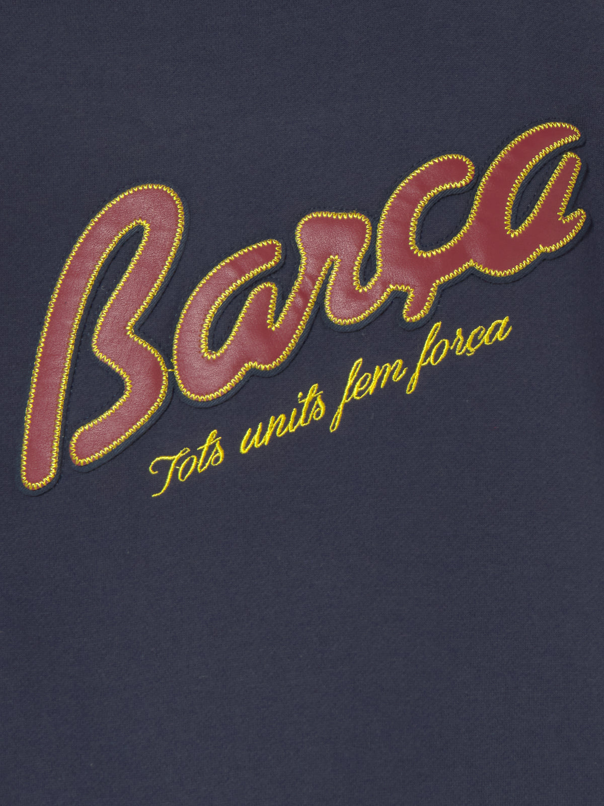 Navy blue FC Barcelona varsity jacket with embroidered 1899 detail, club crest on the chest, and red striped collar, cuffs, and hem.