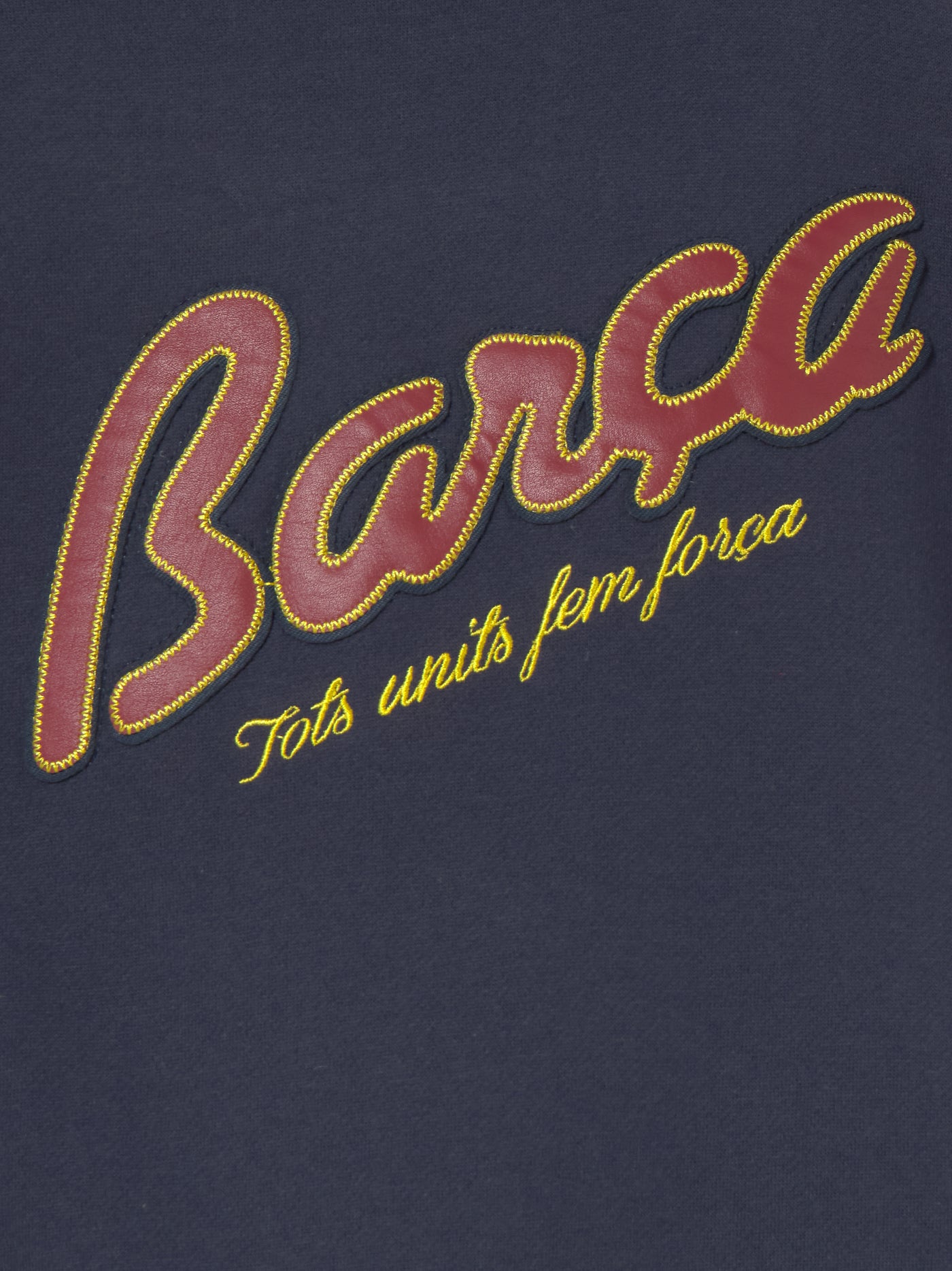 Navy blue FC Barcelona varsity jacket with embroidered 1899 detail, club crest on the chest, and red striped collar, cuffs, and hem.