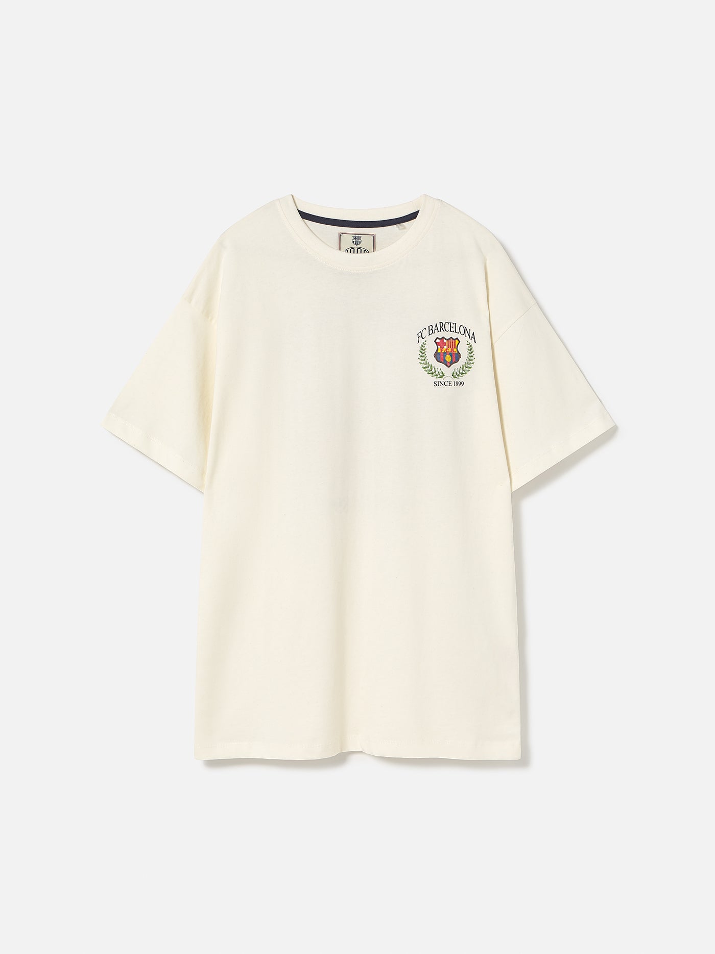Cream T-shirt with large FC Barcelona stadium graphic, laurel wreath design, and 'FC Barcelona Since 1899' text on the back