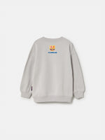  light grey FC Barcelona sweatshirt with a cartoon footballer and the word 'Barça' in blue