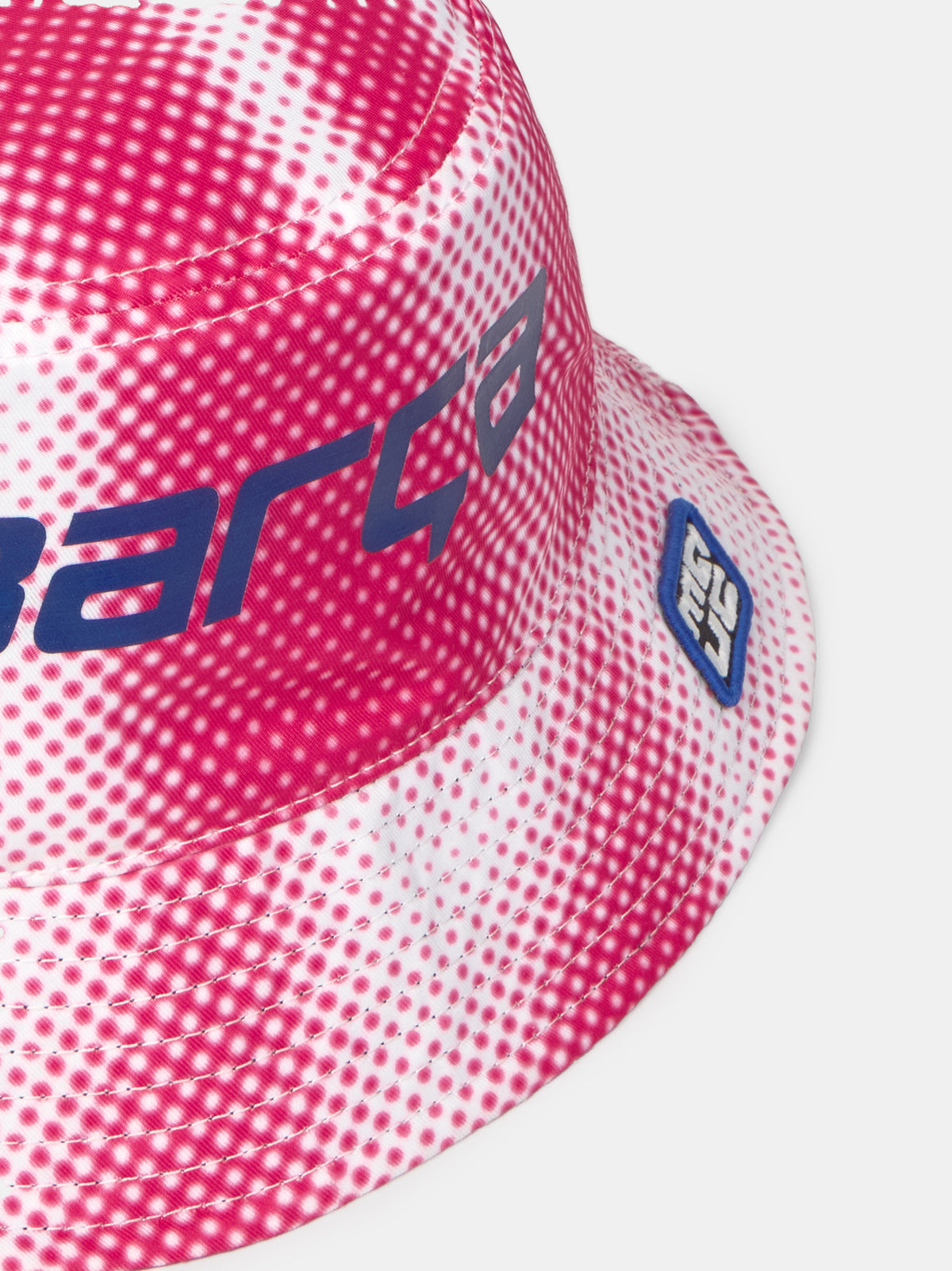 Pink and white bucket hat with dotted pattern and 'Barça' text in blue.