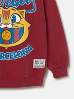  red FC Barcelona hoodie with the text 'Barça' and a cartoon illustration of Cat Culer, the club's mascot, on the front.