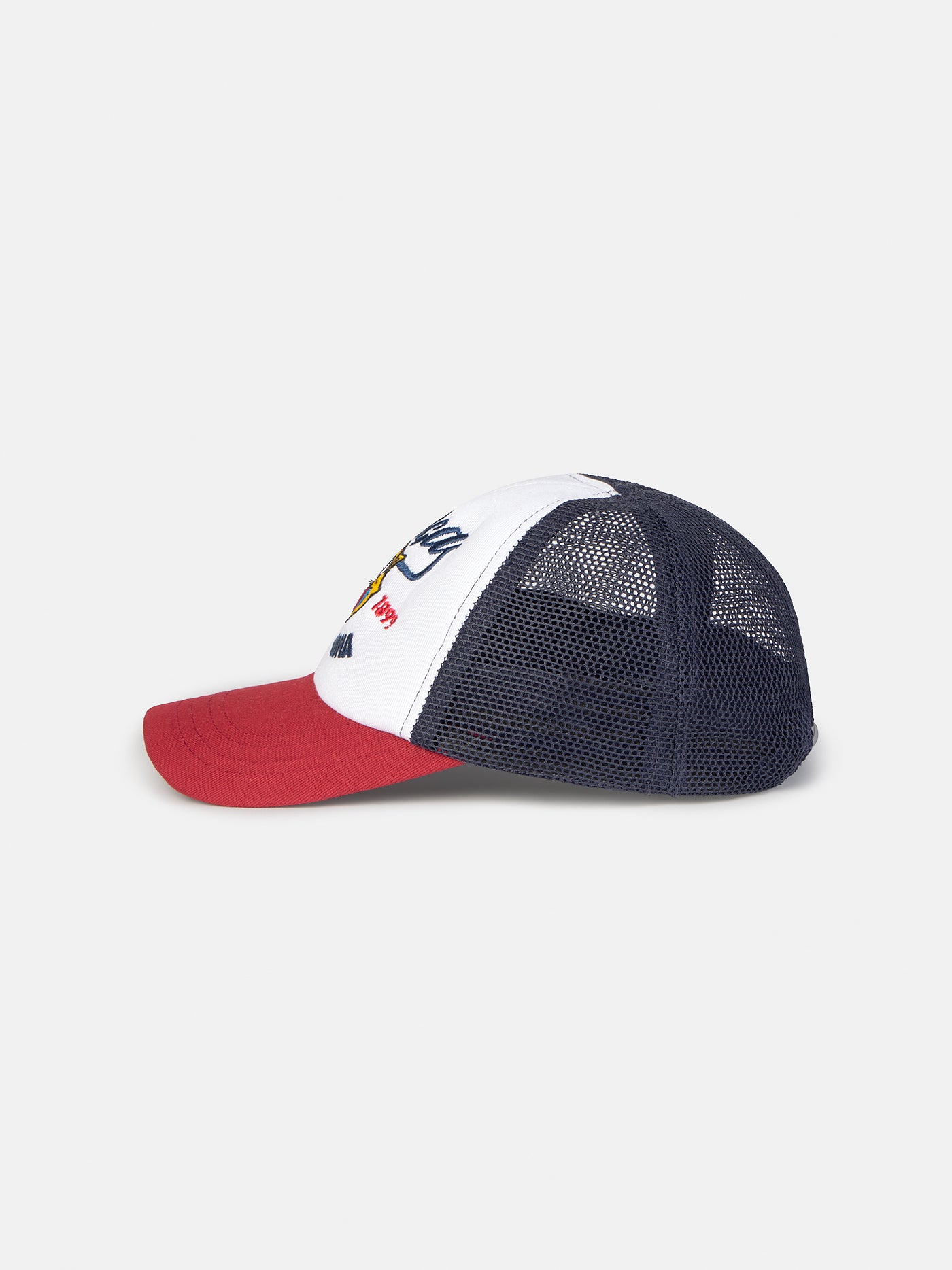 Trucker-style cap with red visor, white front panel featuring a colorful FC Barcelona crest and embroidered 'Barça' text, and black mesh back.